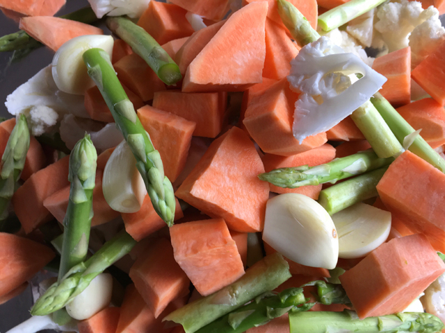 Raw sweet potatoes, asparagus, cauliflower and garlic for Roasted Veggies and Sausages