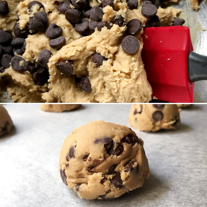 A red spatula in light brown cookie dough and dark chocolate chips