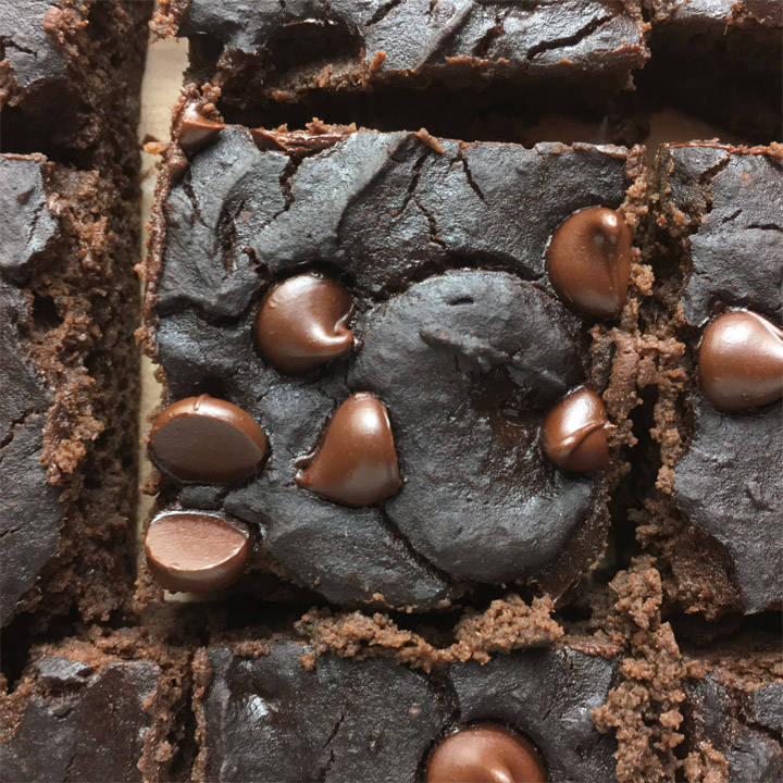 Close-up of a square brownie topped with chocolate chips