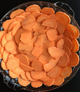 Slices of sweet potato lining a glass dish
