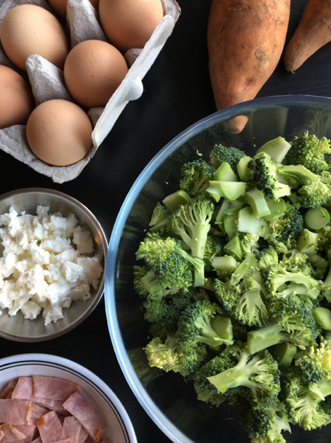 Raw broccoli, chopped ham, sweet potatoes, eggs, and feta for Sweet Potato Broccoli Bacon Quiche