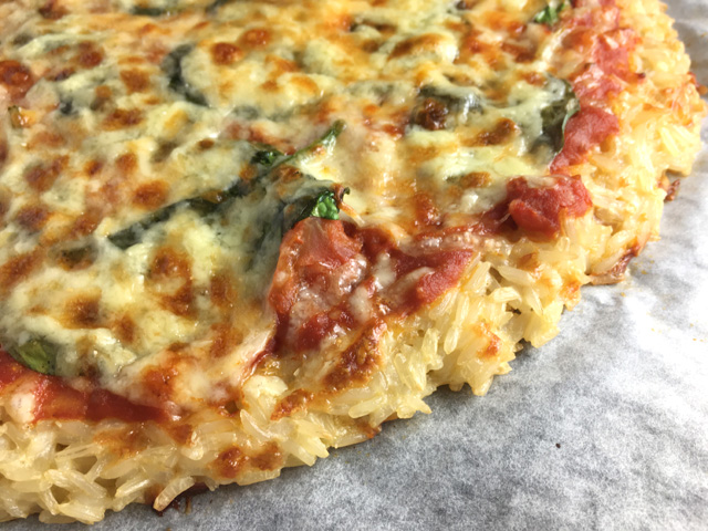 Close-up of Rice Crust Pizza made of rice, tomato sauce, spinach, and cheese