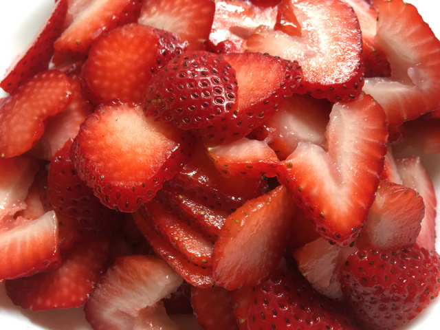 Sliced red strawberries for Strawberry Cloud Crepe Cake