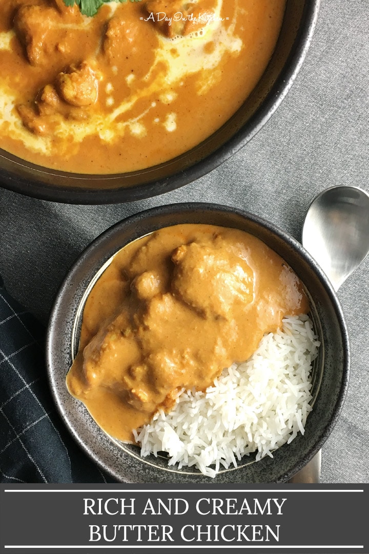 A dark round bowl containing white rice and chicken covered in an orange sauce, the words rich and creamy butter chicken on the bottom