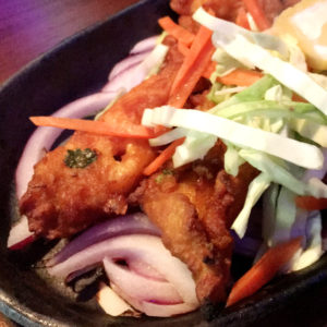 Deep-fried breaded fish with carrots, cabbage, and onions at Hungry Eye Restaurant