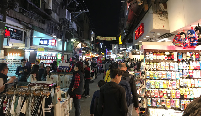 Walking the lane of shops at the Shilin Night Market in Taipei