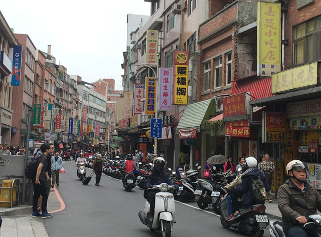 Many motorcycles in the road in Tamsui in Taipei