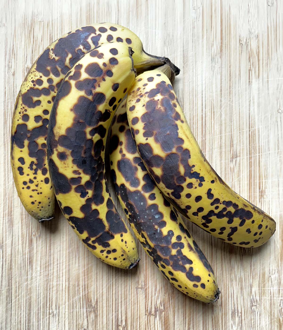 A bunch of bananas very black spotted skins.