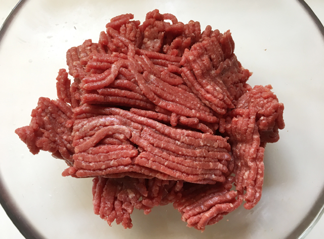 A glass bowl of raw ground beef for homemade hamburger patties