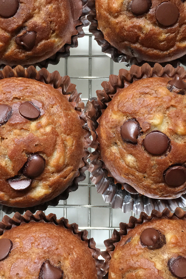 Close-up of 6 banana chocolate chip muffins on a cooling rack