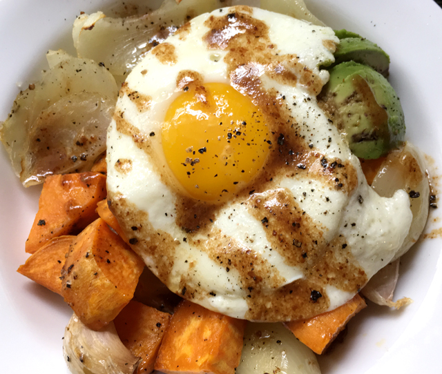 Balsamic vinaigrette drizzled over a fried egg and roasted vegetables