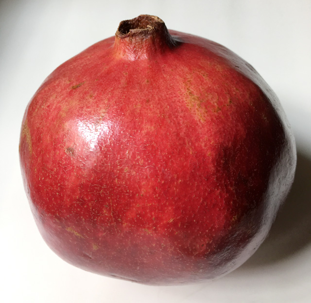 A whole pomegranate for how to open a pomegranate
