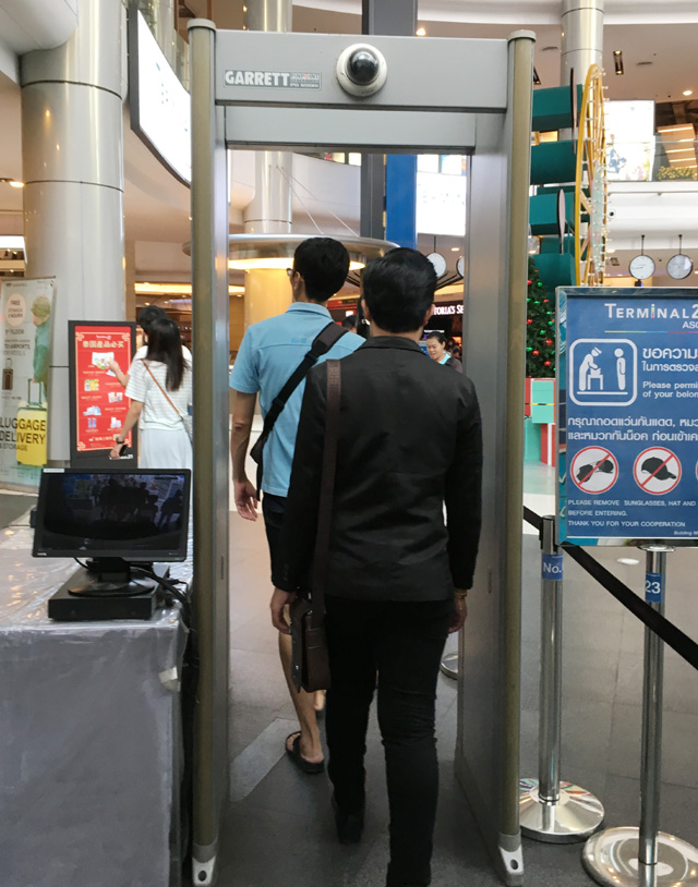 People walking through a metal detector