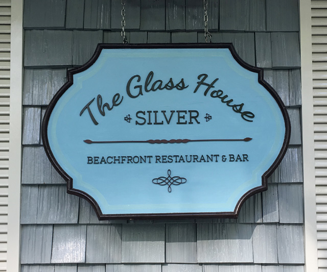 A blue sign that says The Glass House Silver
