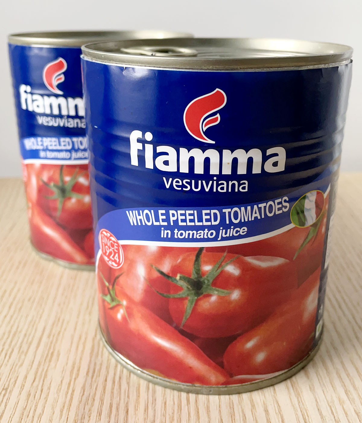 Two cans of whole peeled tomatoes.