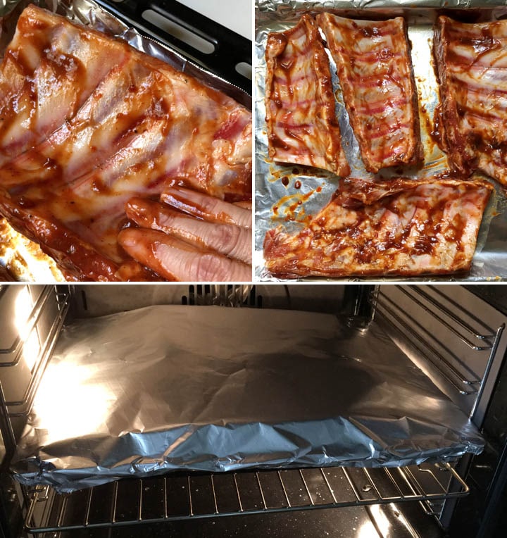 Fingers slathering barbecue sauce on ribs on a baking pan, foil covered pan in an oven
