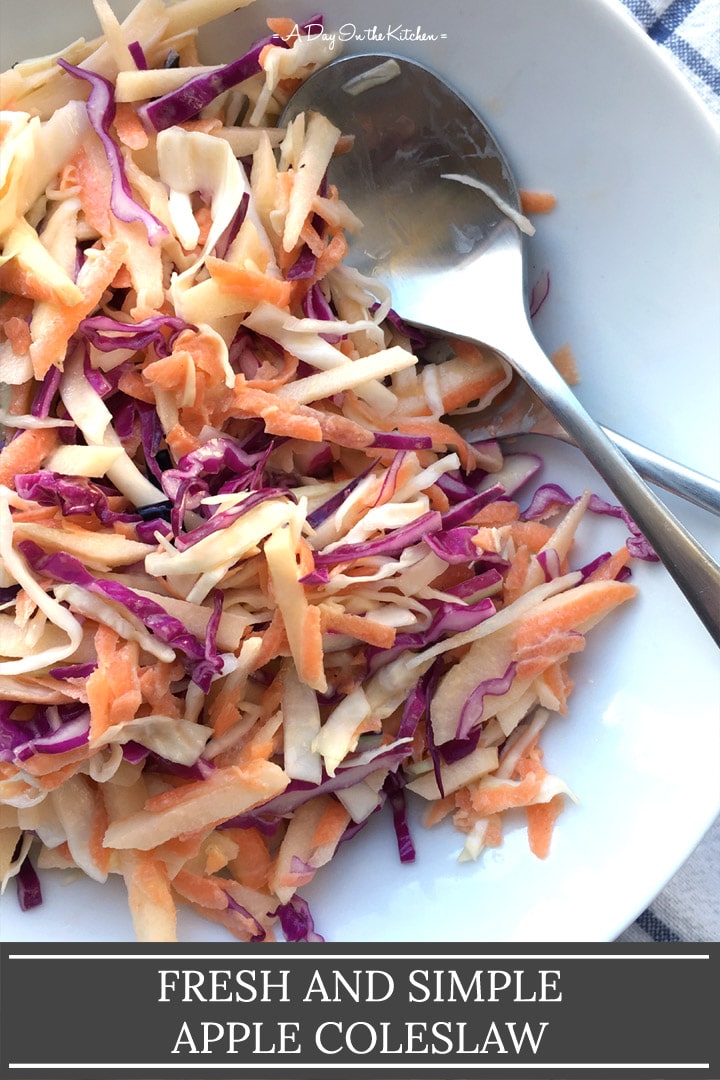 A white round bowl containing two silver spoons and coleslaw, the words fresh and simple apple coleslaw on the bottom
