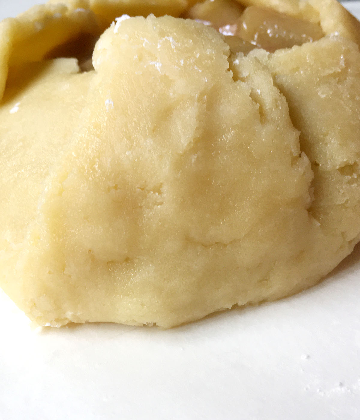 Close-up of pie crust dough with crack sealed up.