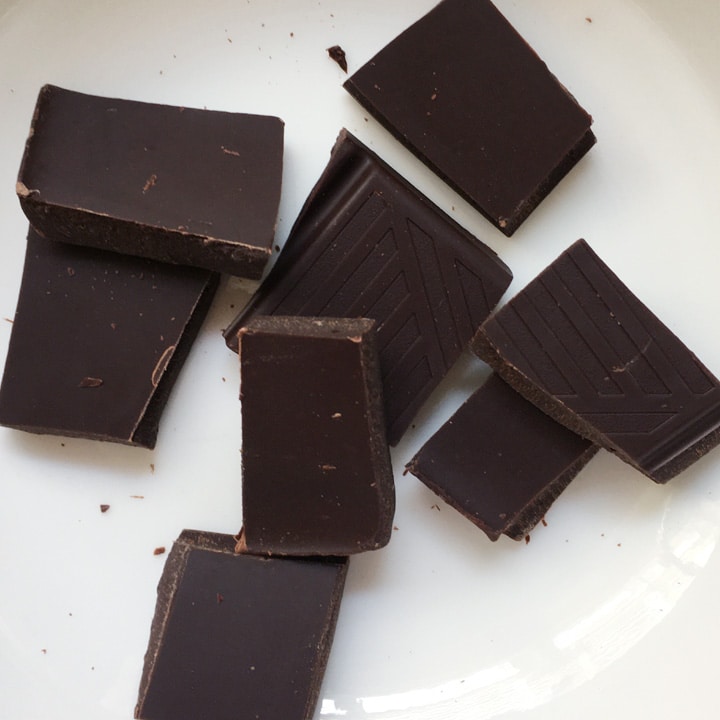 Several pieces of chocolate in a white bowl