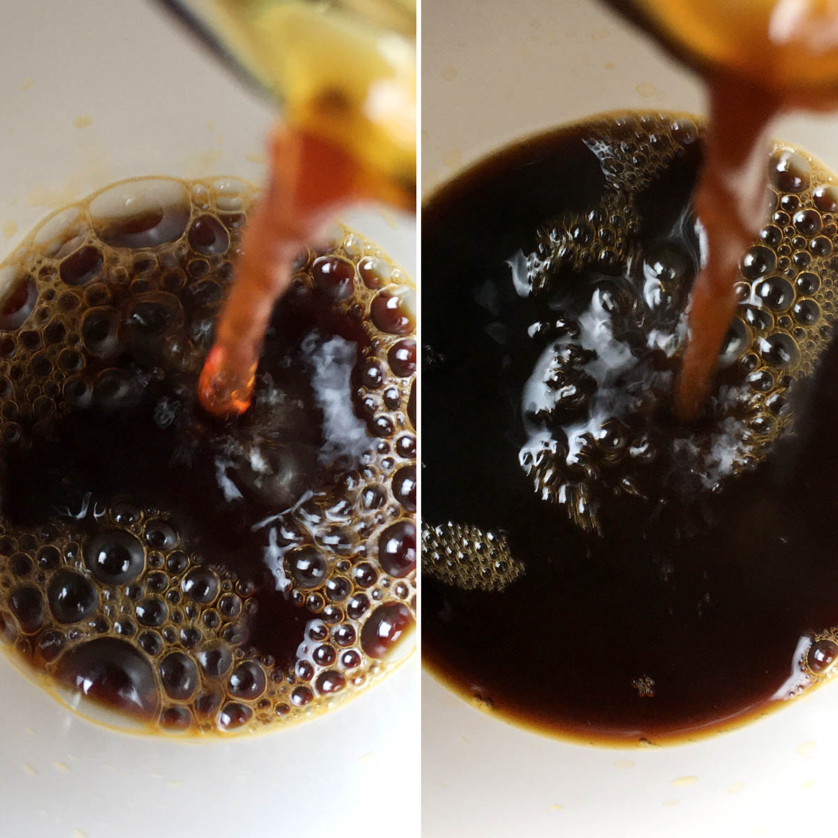 Two dark brown liquids being poured into a white cup.