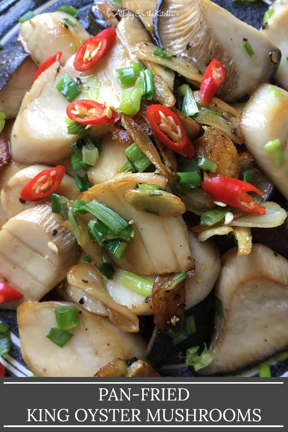 Close-up of sliced mushrooms with brown fried garlic, chopped green onions, and chopped red chili peppers, the words pan-fried king oyster mushrooms on the bottom.