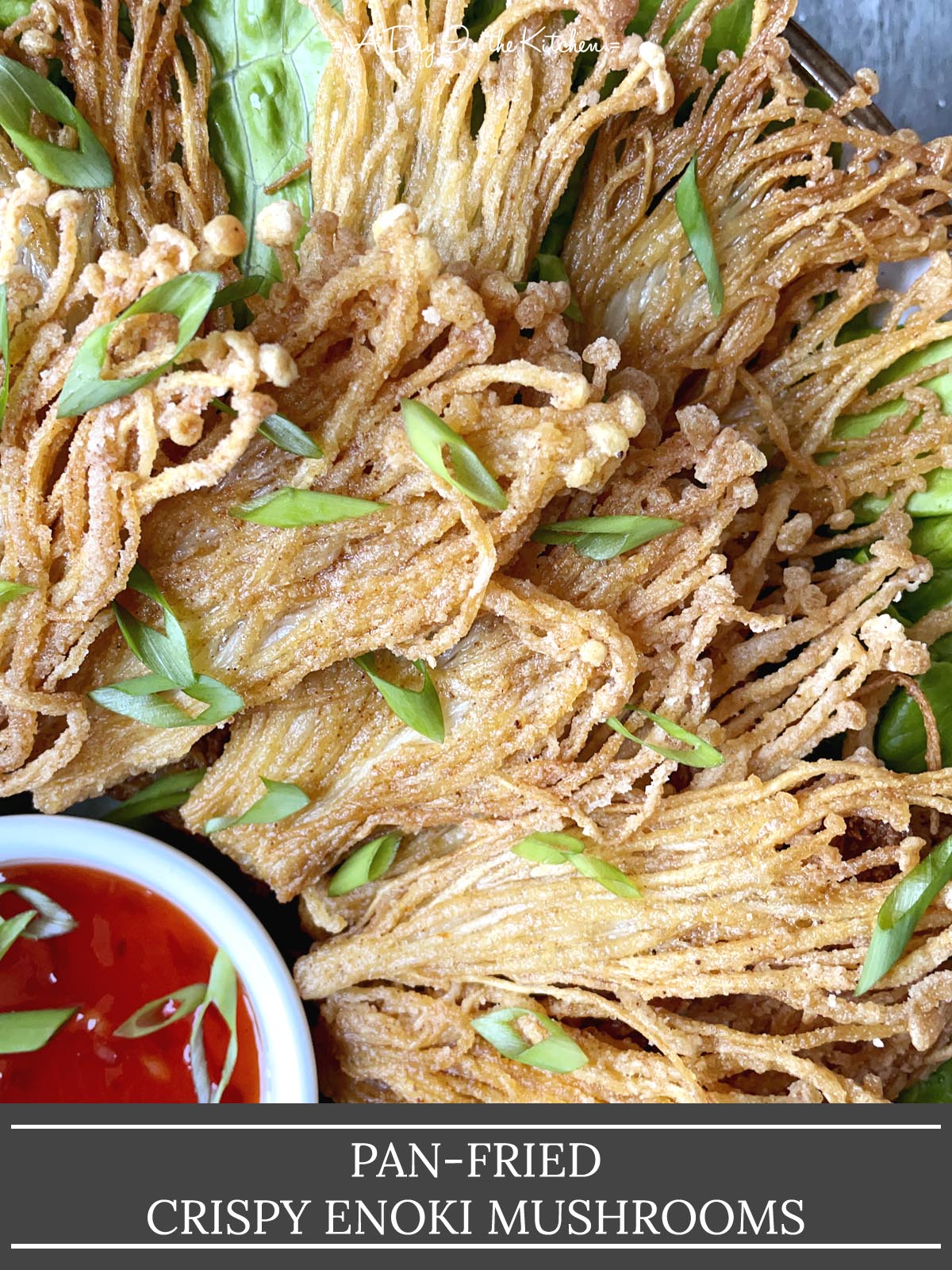Pan-fried Crispy Enoki Mushrooms topped with chopped green onions, next a white dish or chili sauce.