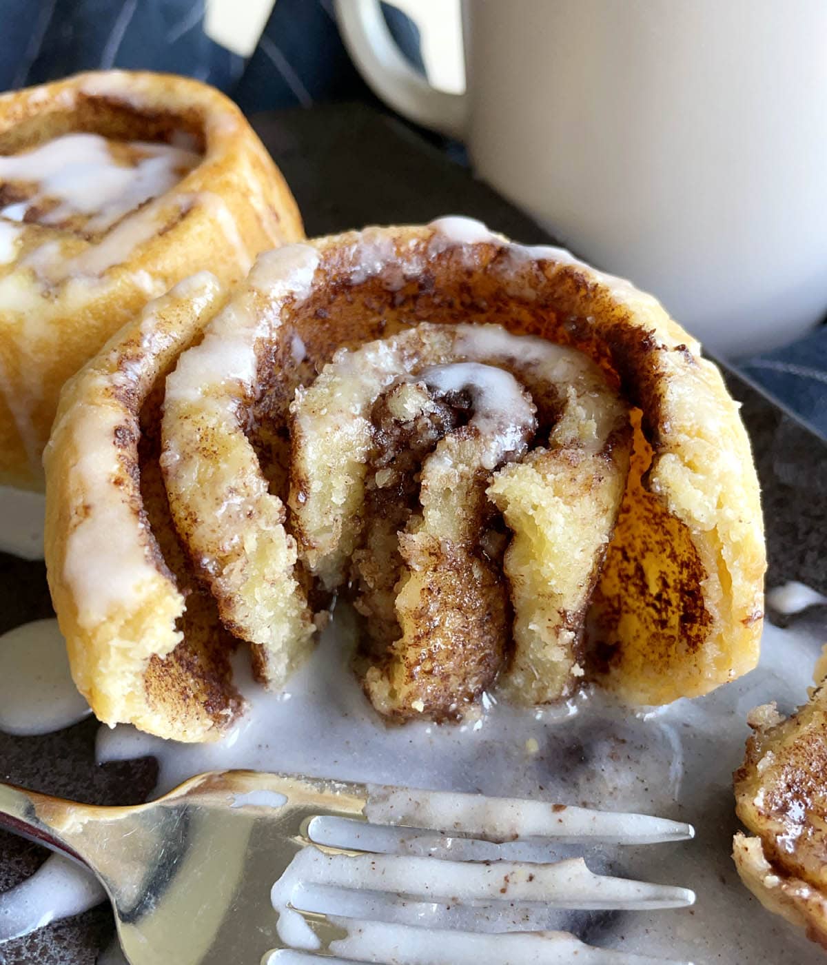 A close-up of the inside of a mochi cinnamon roll with white glaze.